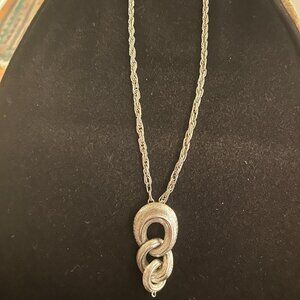 Silver tone link  pendant on braided chain
